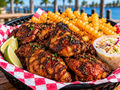 Illustrative jerk chicken basket with fries